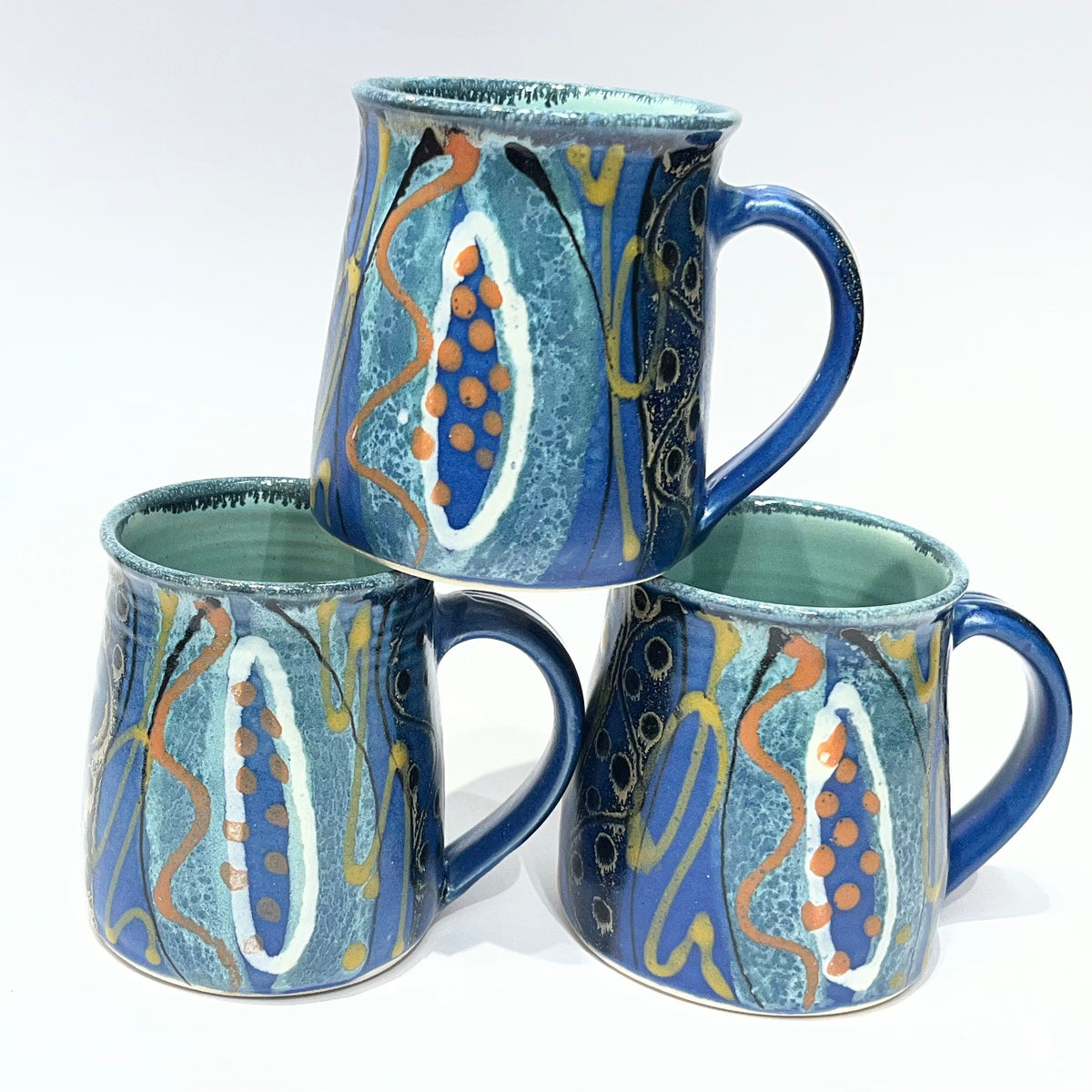 featuring a blue and teal abstract pattern with orange and gold accents by Lea Phillips