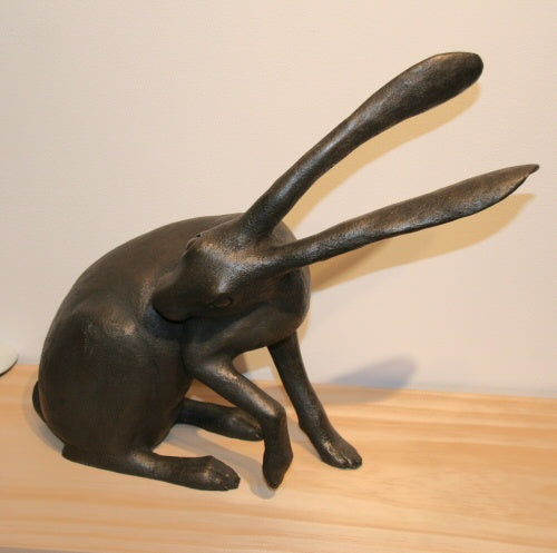 Bronze cast grooming hare by Joanna Martins