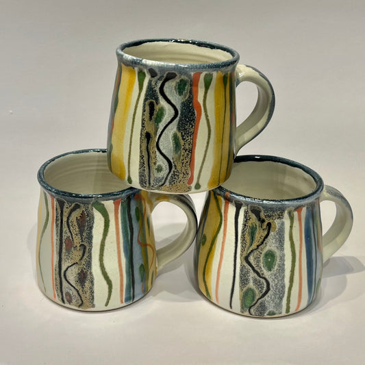 ceramic mugs with a hand-painted abstract design made by lea Phillips
